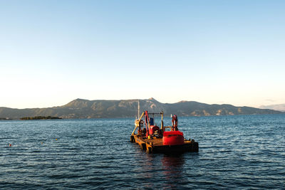 Boat in sea against clear sky