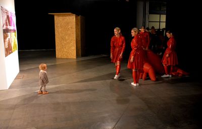 Rear view of people walking on tiled floor