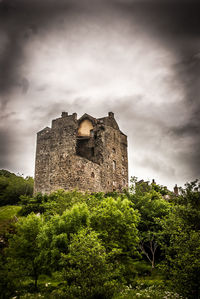 Low angle view of historic building against cloudy sky