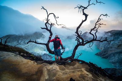 Man on rock by mountain