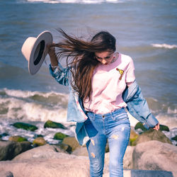 Full length of woman standing at beach