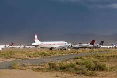 Airplane at aircraft cemetery against sky