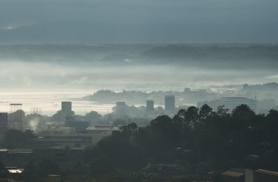 High angle view of trees and buildings against sky