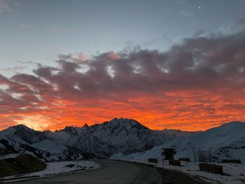 Scenic view of snowcapped mountains against sky during sunset