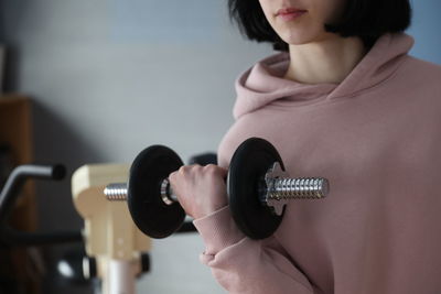 Midsection of woman holding camera