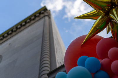 Low angle view of balloons against building