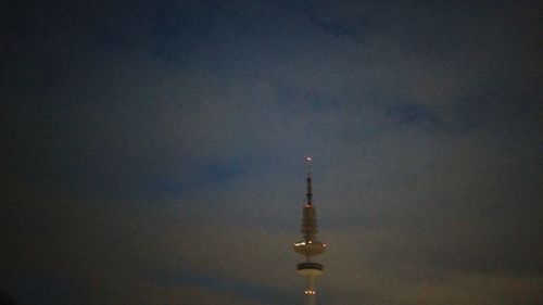 Communications tower against sky at night