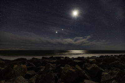 Scenic view of sea against sky at night