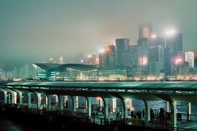 Illuminated modern buildings against sky in city at night