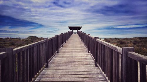 Footbridge against sky