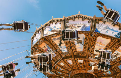 Low angle view of ferris wheel against sky