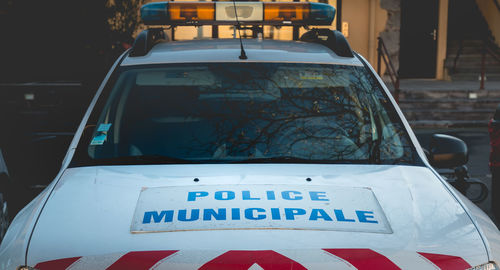 Close-up of information sign on car in city