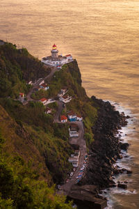 View of farol do arnel, the oldest lighthouse on sao miguel island, azores  at sunrise 