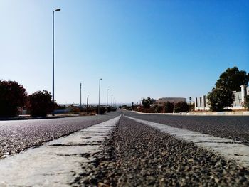 Surface level of road against clear sky