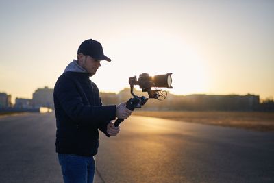 Side view of man photographing