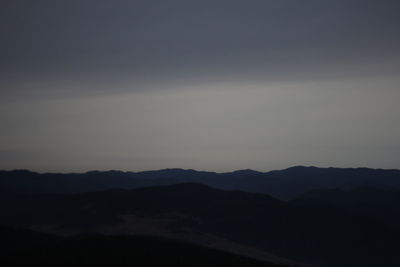 Scenic view of silhouette mountains against sky