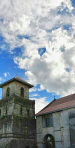 Low angle view of building against cloudy sky