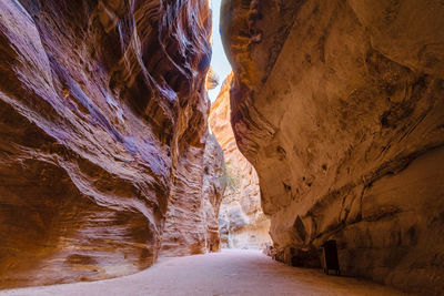 The siq sandstone canyon in petra archeological park, iconic stone carved temples and tombs, jordan