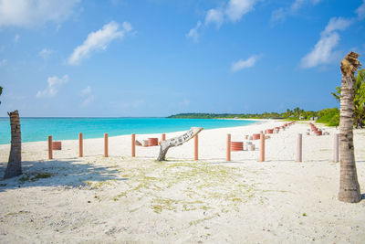 Scenic view of beach against cloudy sky