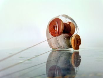 Close-up of water in glass on table against white background