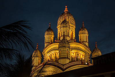 Low angle view of illuminated building against sky at night