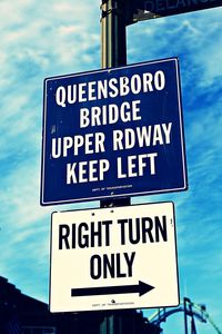 Low angle view of signboard against sky