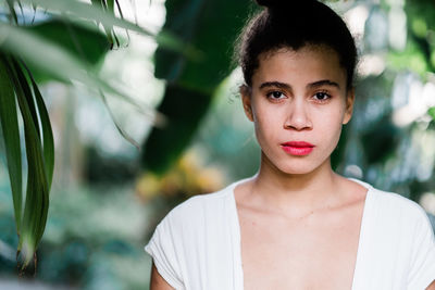 Portrait of teenage girl standing at park