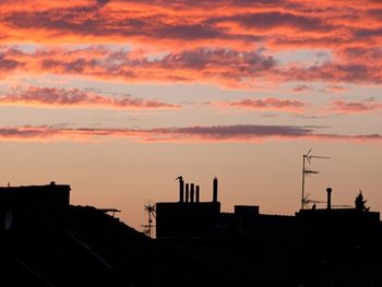 Low angle view of buildings against sky during sunset