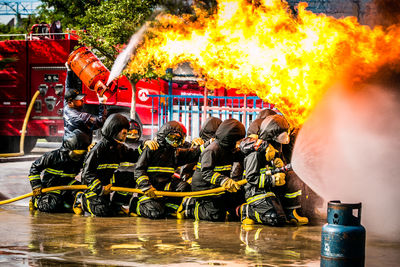 Firefighter spraying water on fire