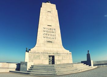 Low angle view of monument against clear blue sky