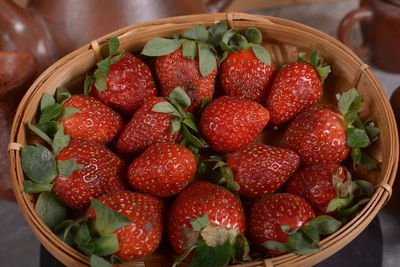 Close-up of a pile of fresh strawberries on a knitting bowl