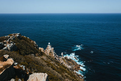 High angle view of rock formation in sea against sky