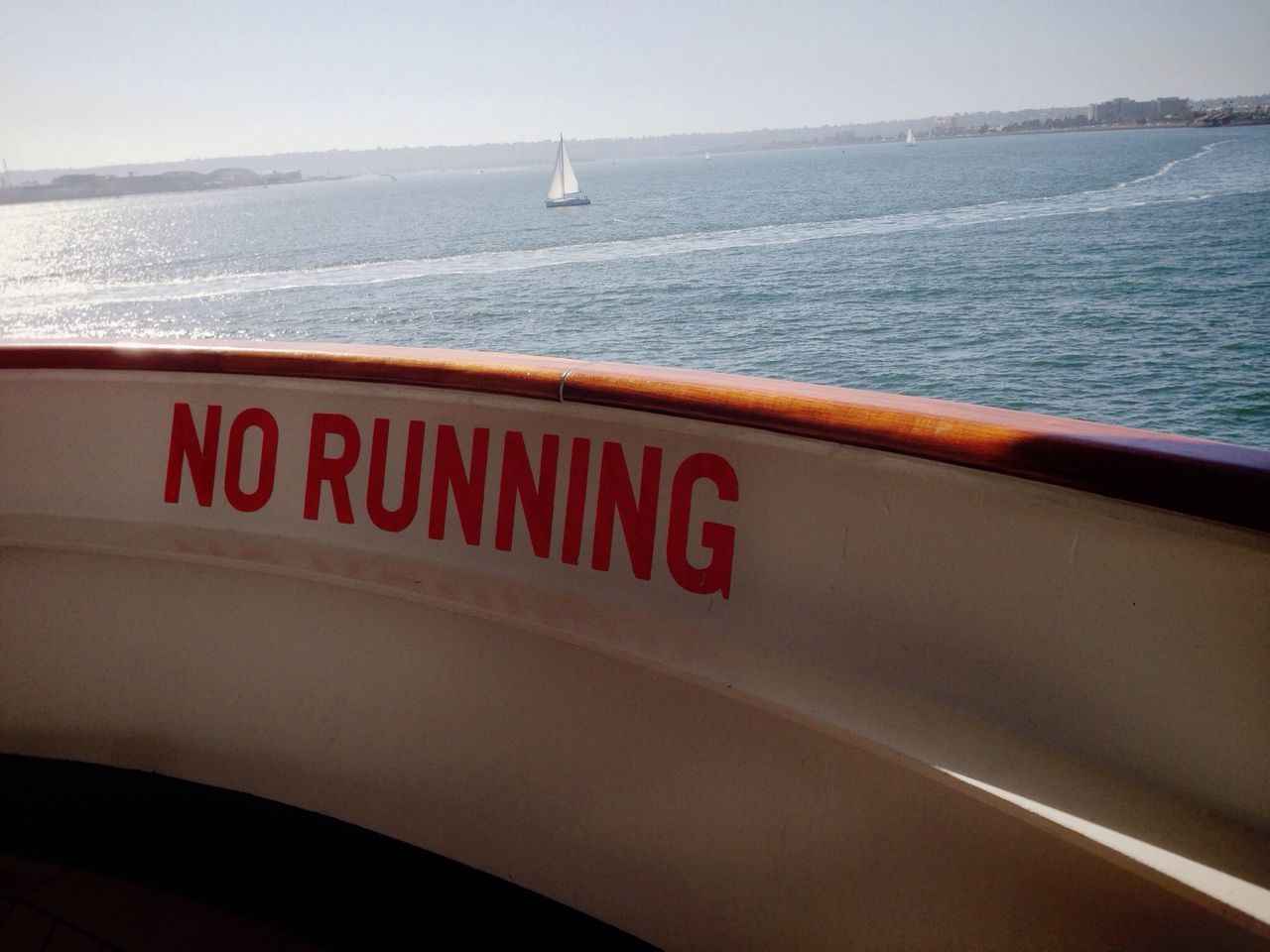 sea, transportation, mode of transport, water, nautical vessel, text, horizon over water, boat, western script, communication, guidance, travel, clear sky, no people, day, outdoors, sky, nature, high angle view, information sign