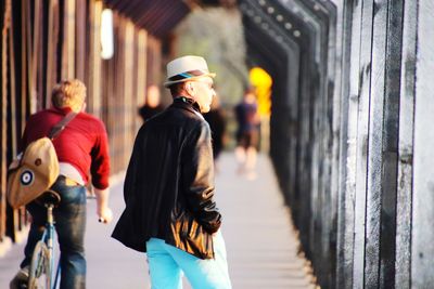 Rear view of men walking outdoors