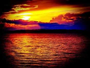 Scenic view of sea against dramatic sky during sunset