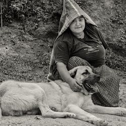 Portrait of dog lying down on land