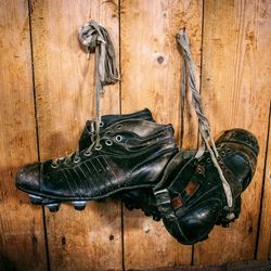 Soccer shoes hanging on wooden wall