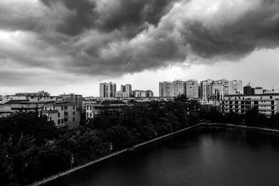 River amidst buildings against sky in city