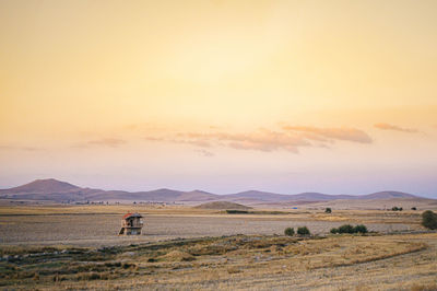 Scenic view of field against sky during sunset