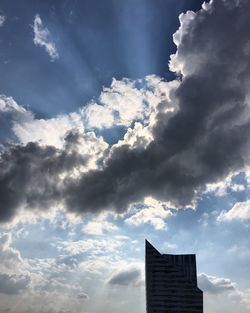 Low angle view of building against cloudy sky