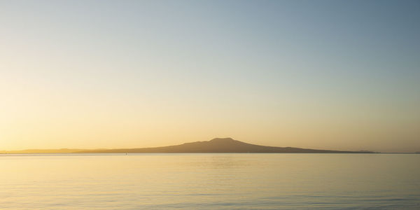 Scenic view of sea against clear sky during sunset