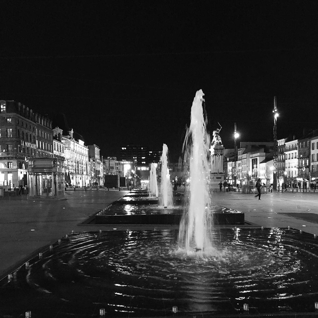 water, architecture, night, motion, fountain, city, built structure, spraying, illuminated, building exterior, long exposure, blurred motion, travel destinations, incidental people, nature, sky, tourism, real people, splashing, outdoors