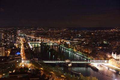 High angle view of illuminated cityscape against sky at night