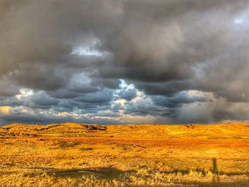 Scenic view of dramatic sky over land