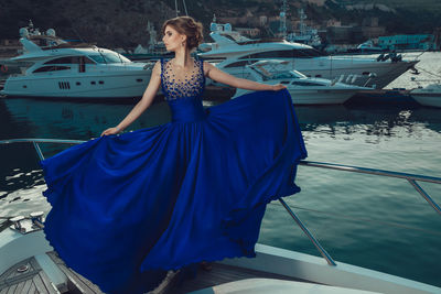 Woman with umbrella on boat in water