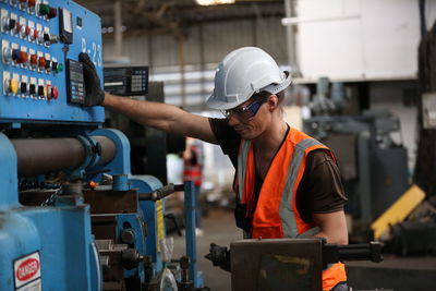 Side view of man working in factory