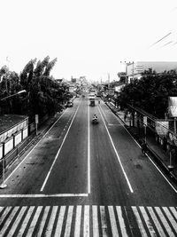 Road by city against clear sky