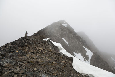 Man stands in whiteout on cooper mountain, kenai peninsula, alaska