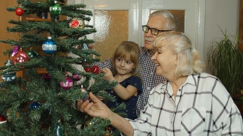 Family decorating christmas tree