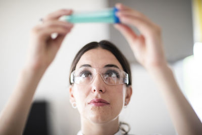 Scientist female with lab glasses, tablet and sample in a lab